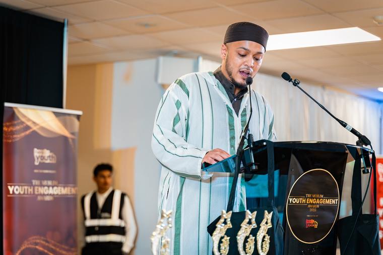 A guest speaking at the lectern during the ceremony.